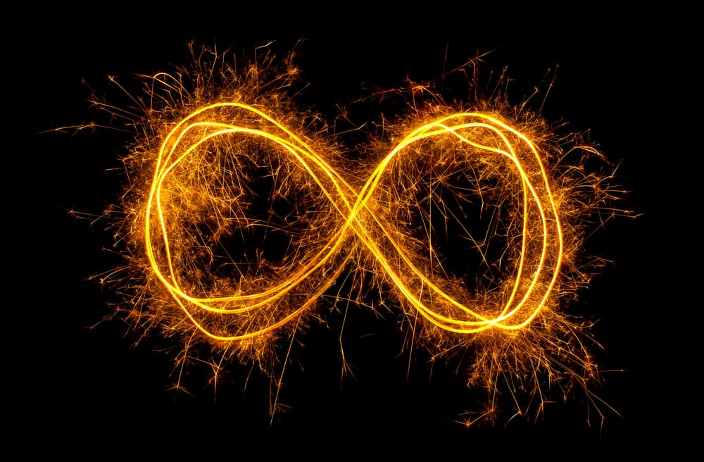 Glowing moebius strip infinity symbol isolated on black background